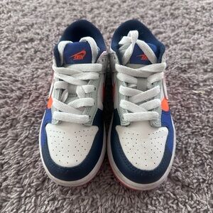 Preloved Nike Kids Navy and White Sneakers with Orange Accents